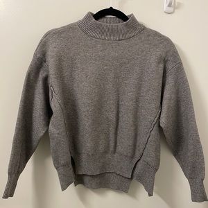 Thick mock neck sweater, great material. Shorter fit